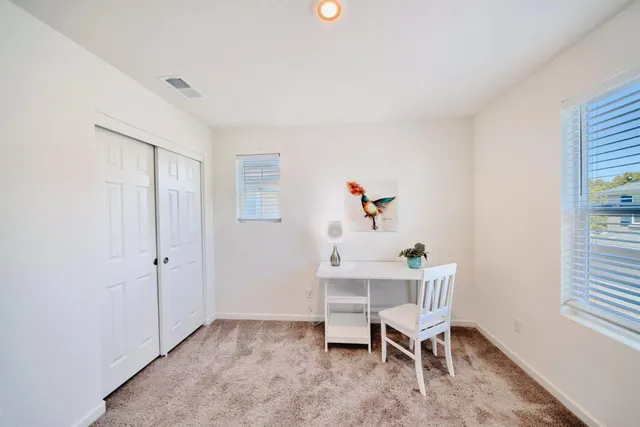 a spacious bathroom with a shower a sink and a mirror