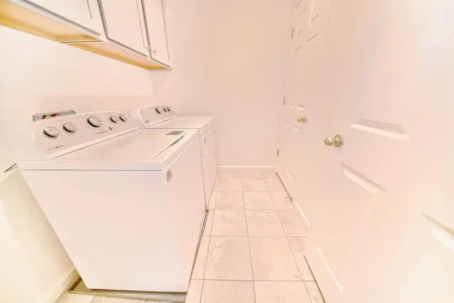 a bedroom with a bed and a potted plant