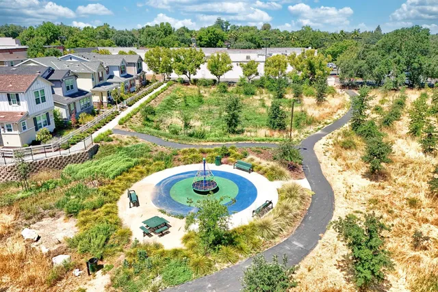 an aerial view of residential houses with outdoor space