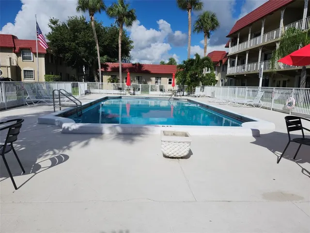 a view of a swimming pool with lounge chairs