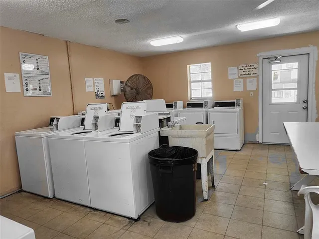 a living room with furniture a dining table and kitchen view