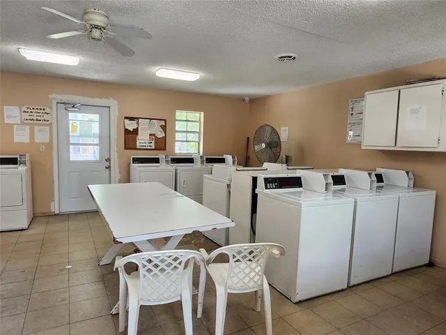 a living room with furniture a dining table and chairs