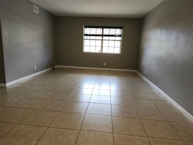 a kitchen with granite countertop a stove top oven microwave and cabinets