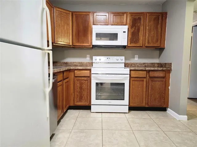 a kitchen with granite countertop cabinets stainless steel appliances and a sink
