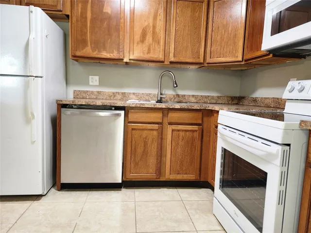 a kitchen with stainless steel appliances granite countertop a refrigerator and microwave
