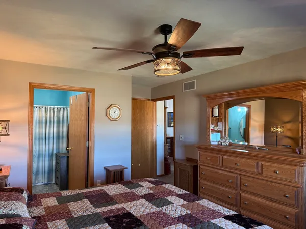 a bathroom with a granite countertop toilet sink and a mirror