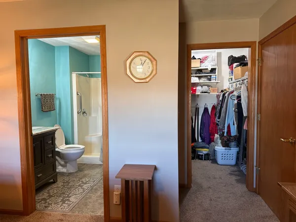 a kitchen with stainless steel appliances granite countertop a stove top oven a sink a dining table and chairs with wooden floor