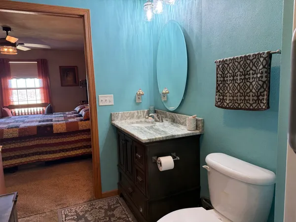 a kitchen with granite countertop a sink a stove and cabinets