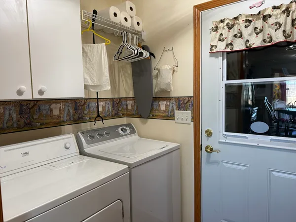 a living room with furniture a flat screen tv and a wall clock