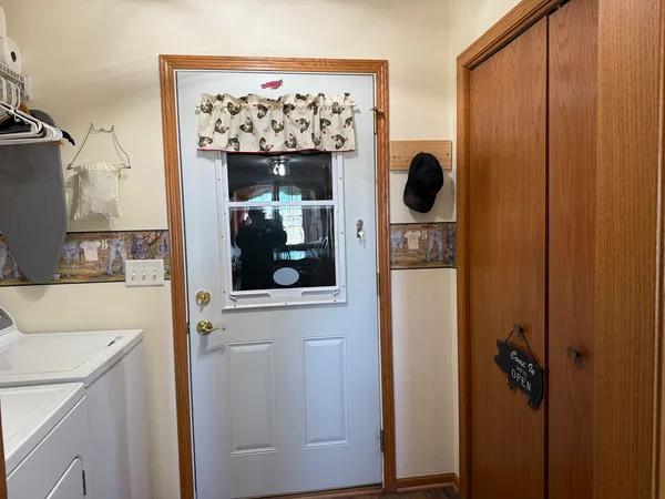 a kitchen with a refrigerator a sink and a dining table