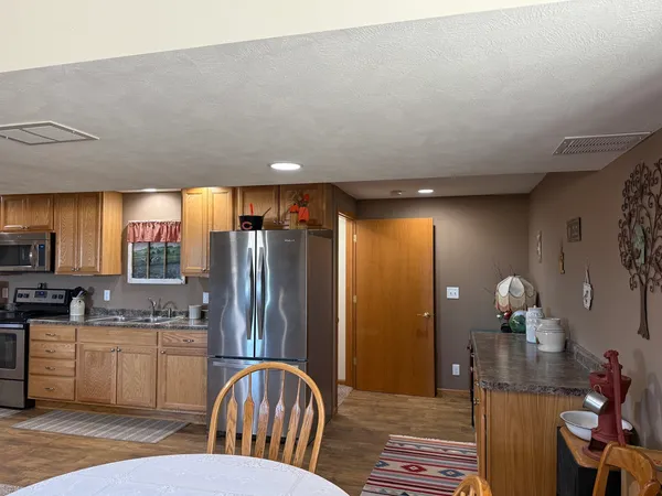 a kitchen with stainless steel appliances a refrigerator stove and microwave