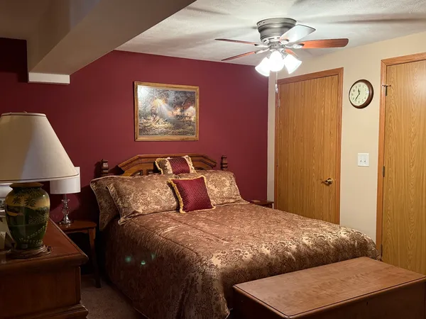 a view of a patio with table and chairs and wooden fence
