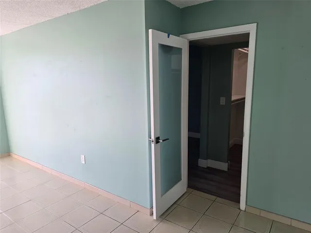 an empty room with wooden floor and closet