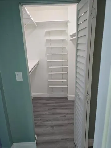 a bathroom with a granite countertop toilet a sink and a mirror
