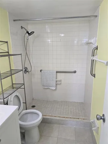 a view of a refrigerator in kitchen and utility room