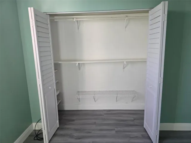 a kitchen with a refrigerator and a stove top oven