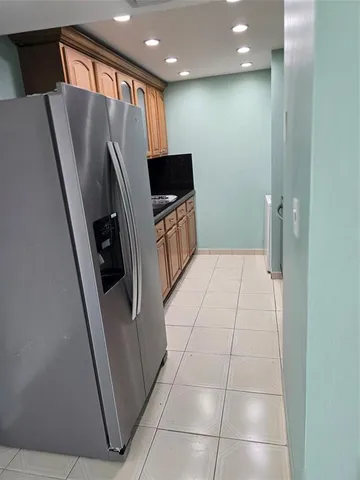 a kitchen with granite countertop a sink and a white cabinets