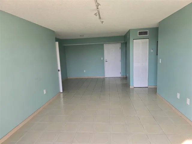 an empty room with wooden floor and a window