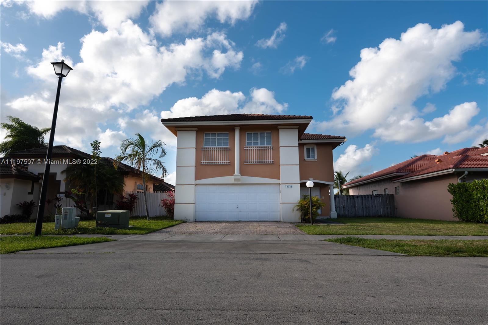 15341 Southwest 36th Street Miami, FL 33185 - Photo 2 of 3 a front view of a house with a garden