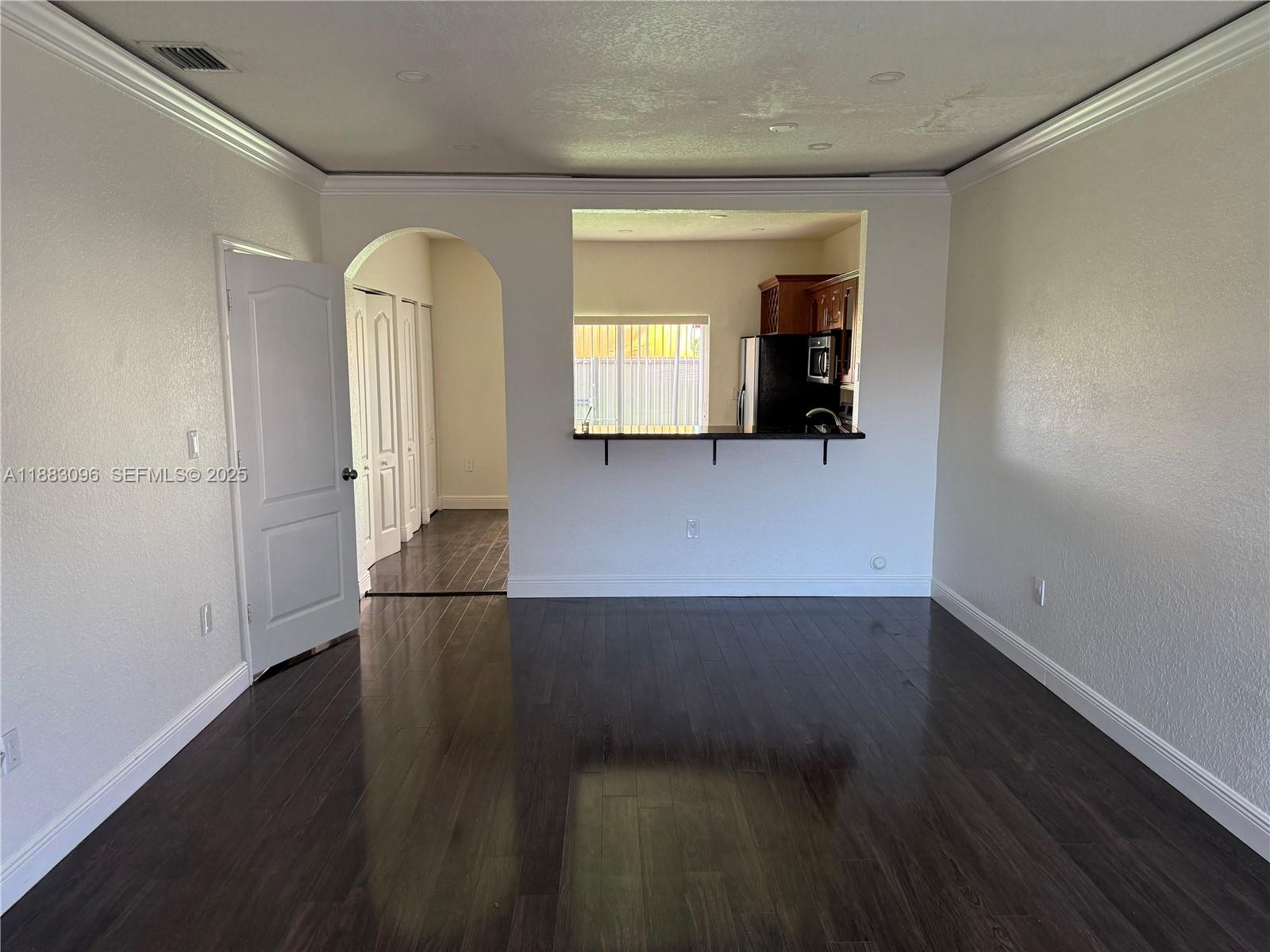 17018 Southwest 138th Court Miami, FL 33177 - Photo 19 of 22 an empty room with wooden floor and windows