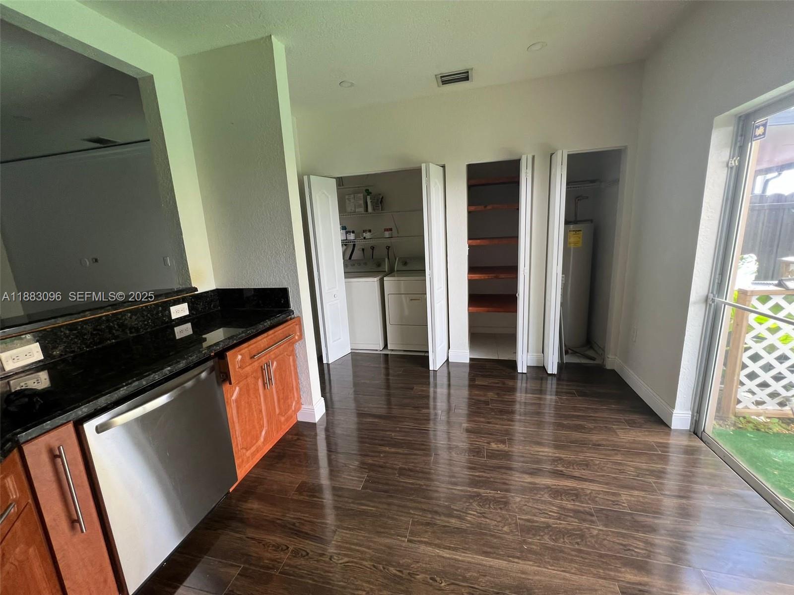 17018 Southwest 138th Court Miami, FL 33177 - Photo 4 of 22 a view of an empty room with wooden floor and a window