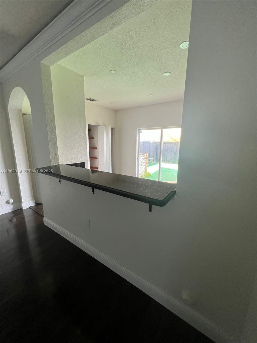 17018 Southwest 138th Court Miami, FL 33177 - Photo 5 of 22 wooden floor in an empty room with a window