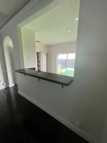 a view of an empty room and wooden floor