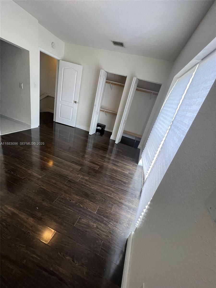 17018 Southwest 138th Court Miami, FL 33177 - Photo 7 of 22 a view of an entryway with wooden floor
