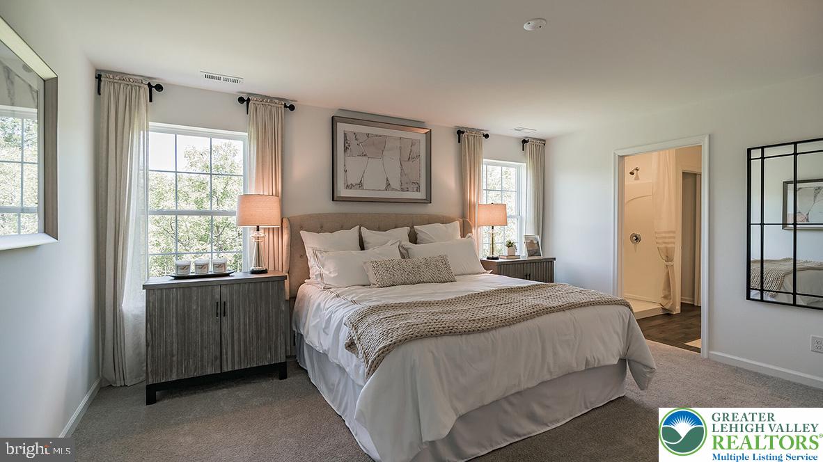 115 Winding Road Easton, PA 18040 - Photo 11 of 24 Relax in this inviting primary bedroom featuring abundant natural light and an adjacent private bathroom.