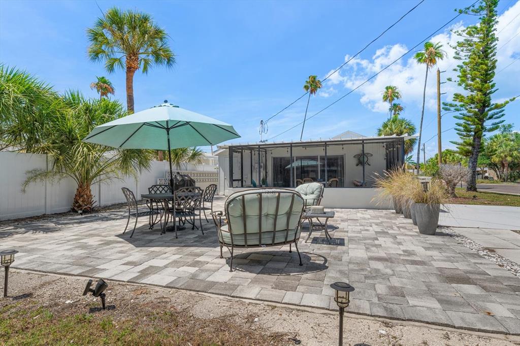 127 11th Avenue Indian Rocks Beach, FL 33785 - Photo 28 of 63 a view of a chairs and table in backyard