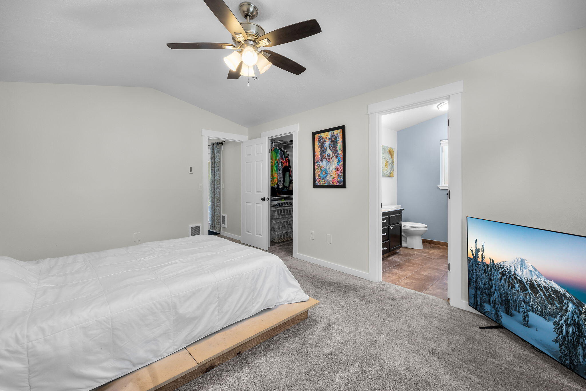 1255 Southwest 28th Street Redmond, OR 97756 - Photo 22 of 40 a spacious bedroom with a bed and a chandelier