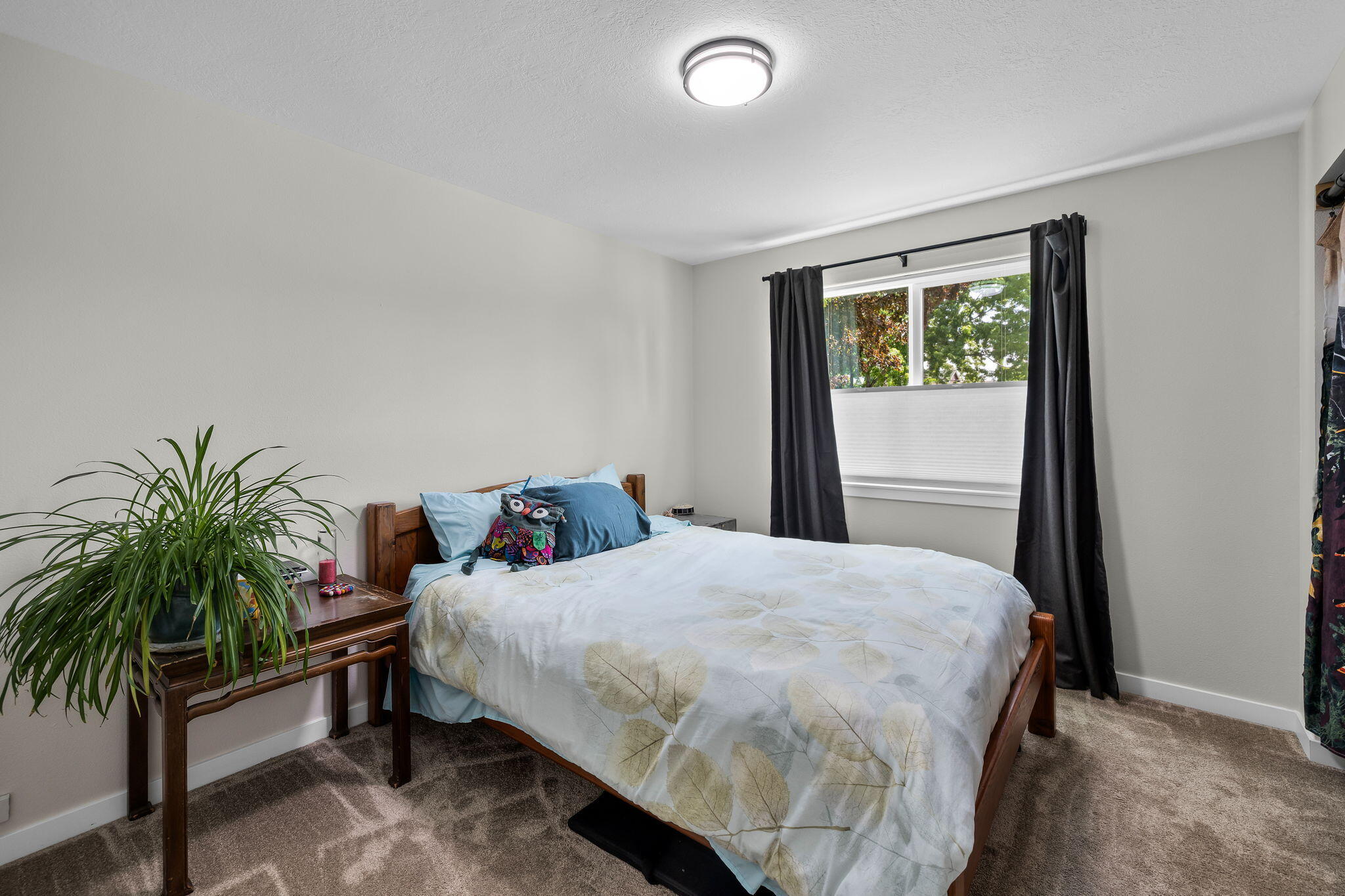 1255 Southwest 28th Street Redmond, OR 97756 - Photo 25 of 40 a bedroom with a bed lamp and a potted plant