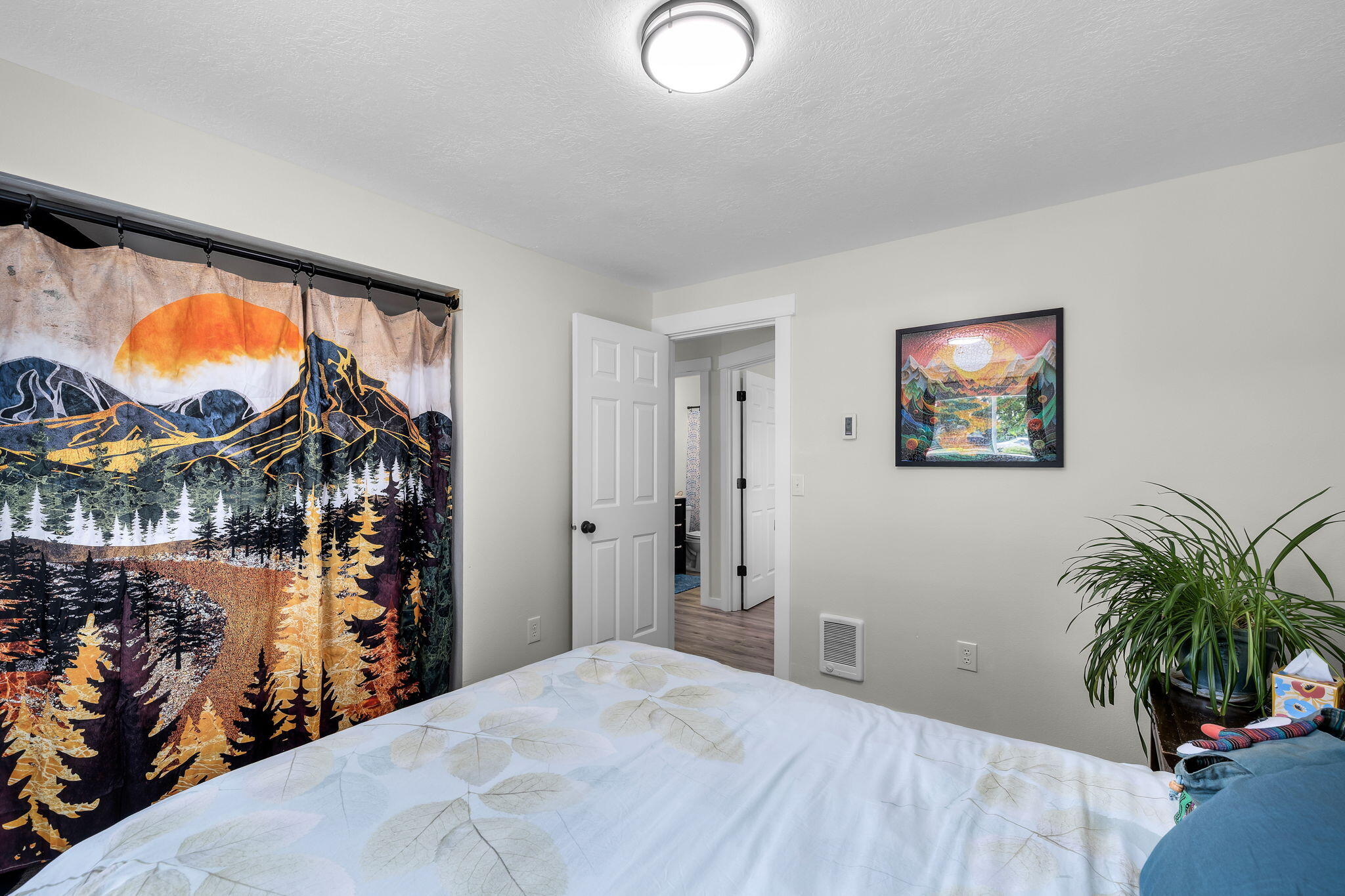 1255 Southwest 28th Street Redmond, OR 97756 - Photo 27 of 40 a bedroom with a bed and a potted plant