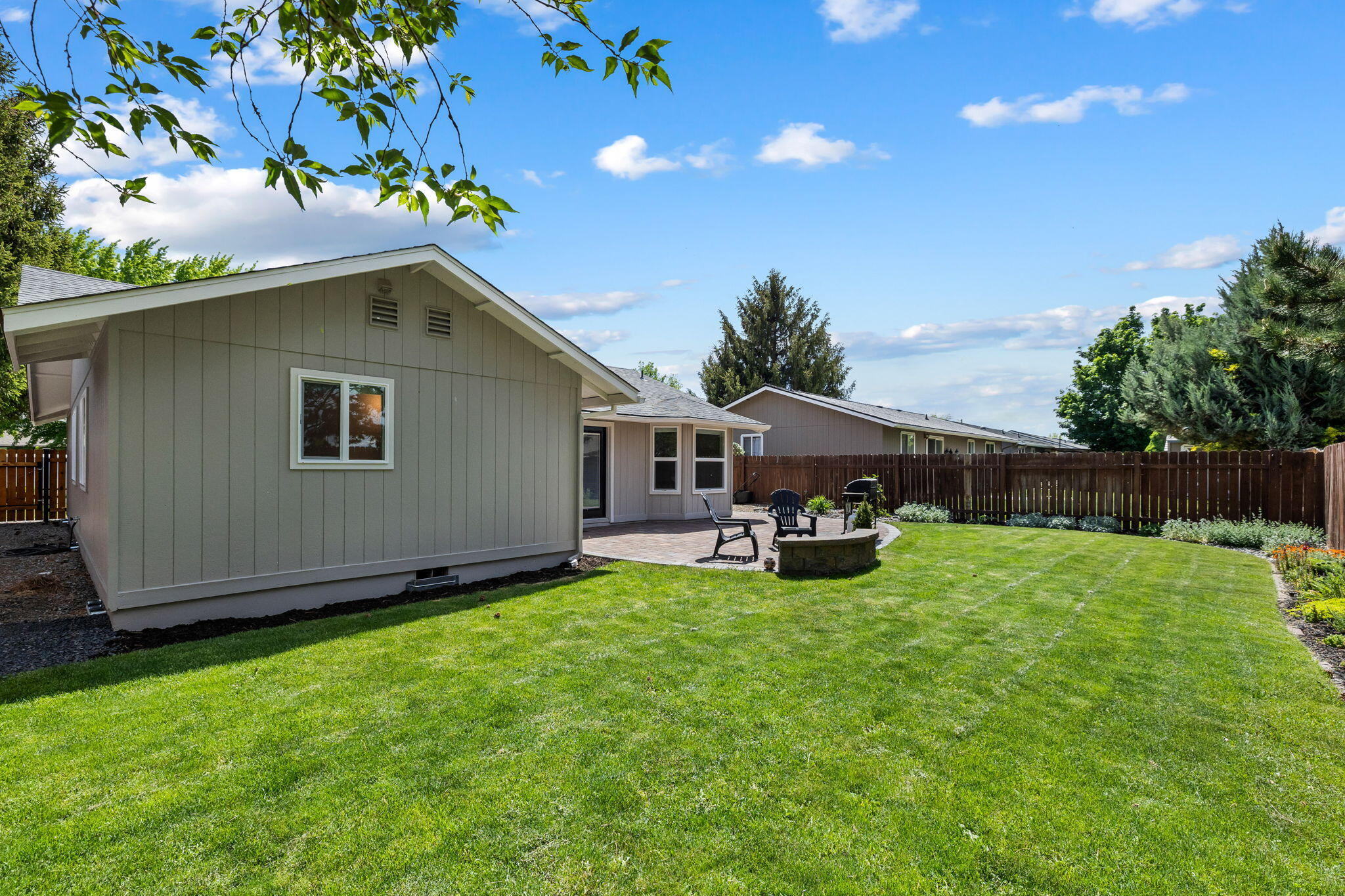 1255 Southwest 28th Street Redmond, OR 97756 - Photo 32 of 40 a view of a backyard with table and chairs and potted plants with wooden fence