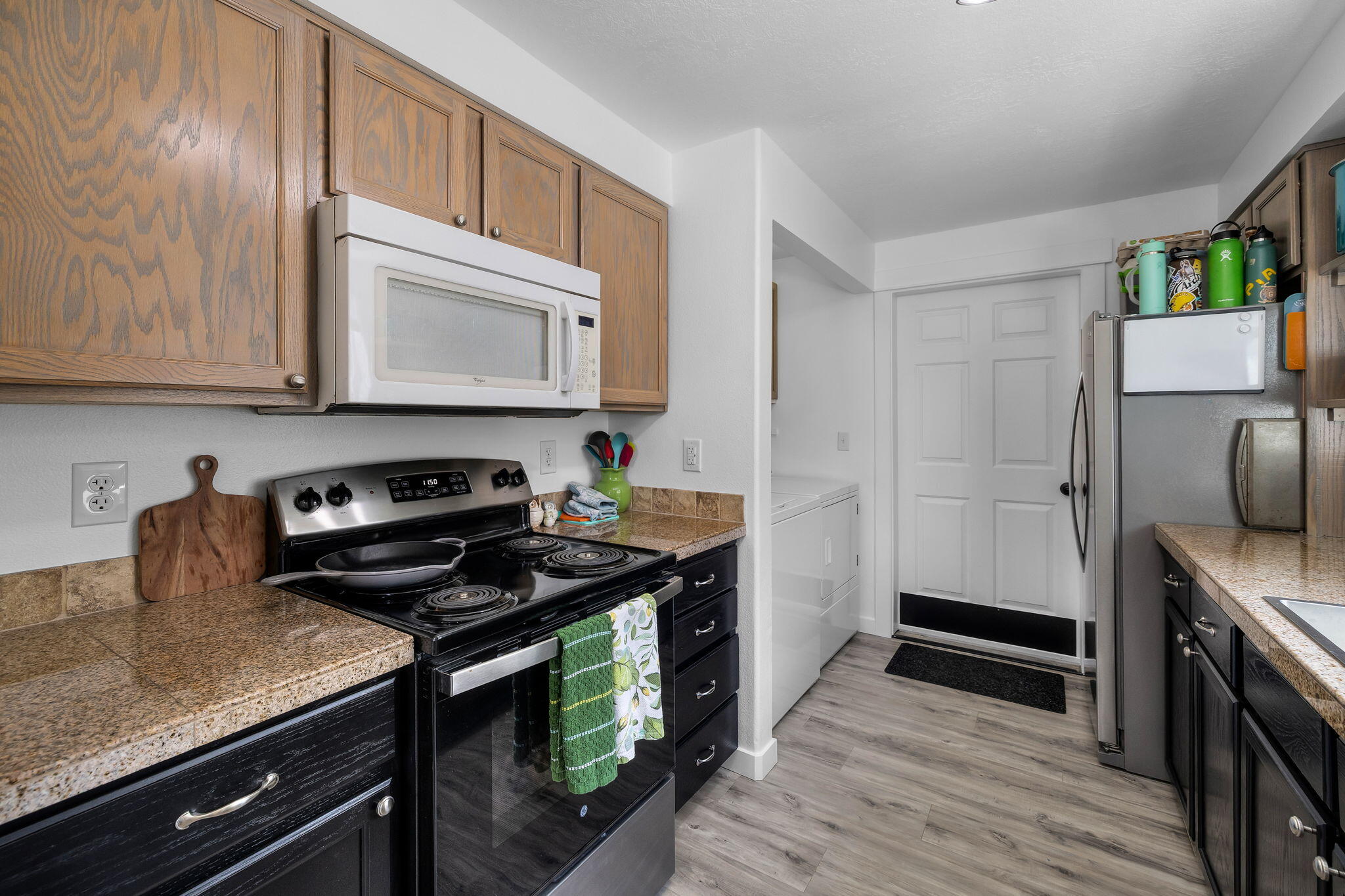 1255 Southwest 28th Street Redmond, OR 97756 - Photo 5 of 40 a kitchen with stainless steel appliances a stove a sink and cabinets