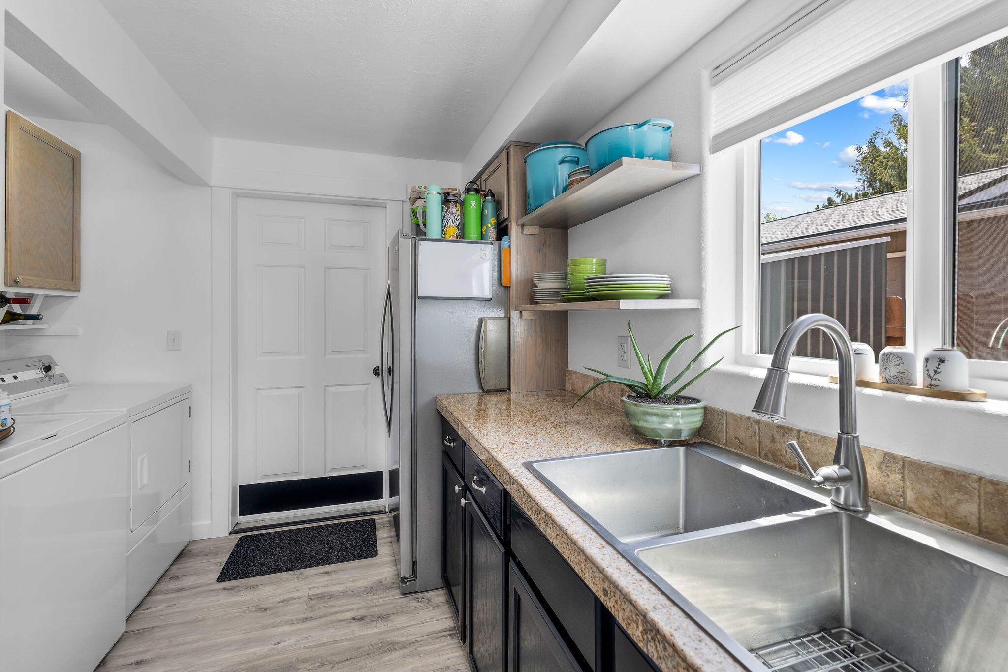 1255 Southwest 28th Street Redmond, OR 97756 - Photo 6 of 40 a kitchen with a sink a counter top space and stainless steel appliances