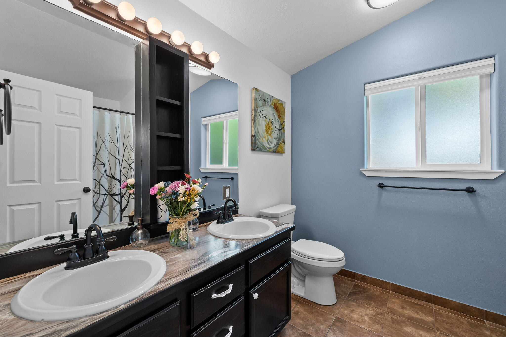 1255 Southwest 28th Street Redmond, OR 97756 - Photo 9 of 40 a bathroom with a double vanity sink toilet and a mirror