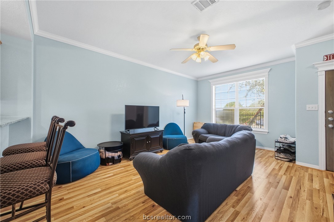 1000 Spring Loop, Unit 2105 College Station, TX 77840 - Photo 2 of 22 a living room with furniture and a flat screen tv