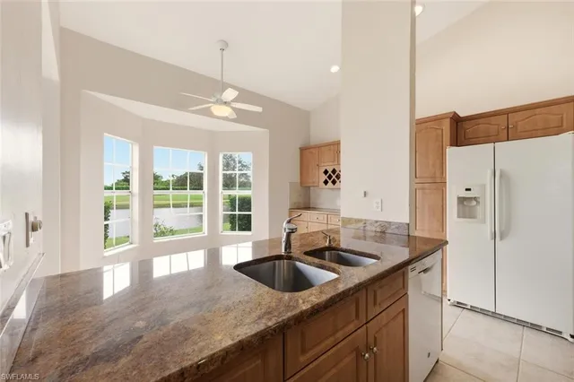 a kitchen with granite countertop a sink and a stove