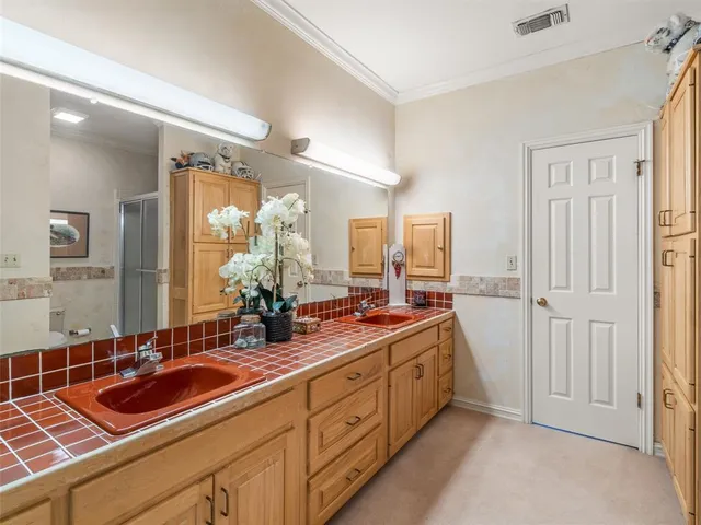 a spacious bathroom with double sink and a large mirror