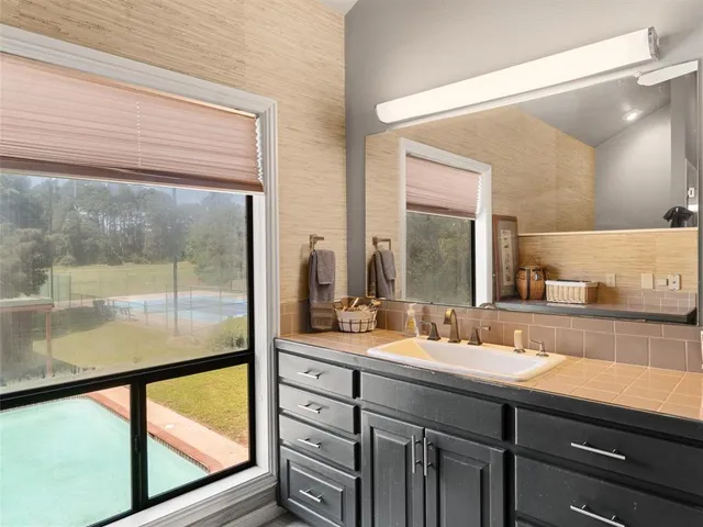 a bathroom with a double vanity sink and a mirror