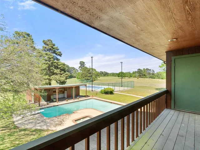 a balcony with wooden floor and fence