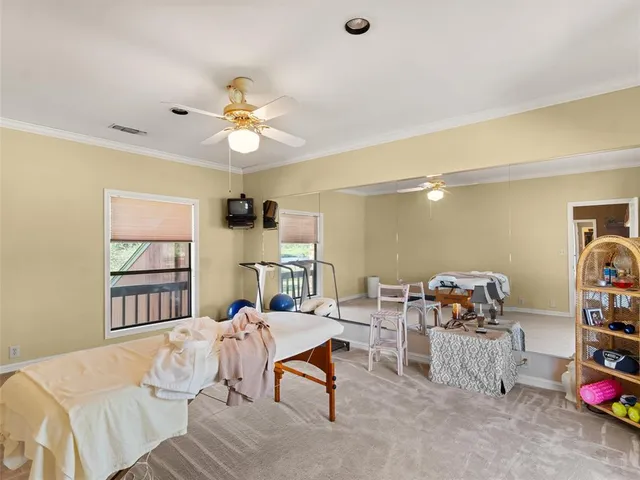 a bedroom with bed and a chandelier