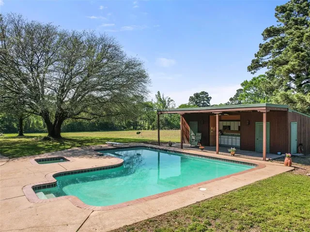 a view of a house with swimming pool and sitting area