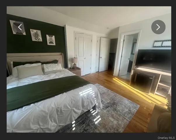 a bedroom with a bed and a black white bedspread