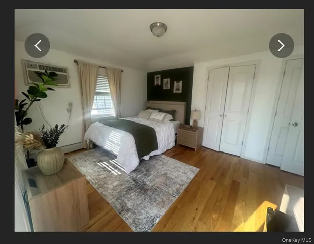 a bedroom with a bed and a potted plant