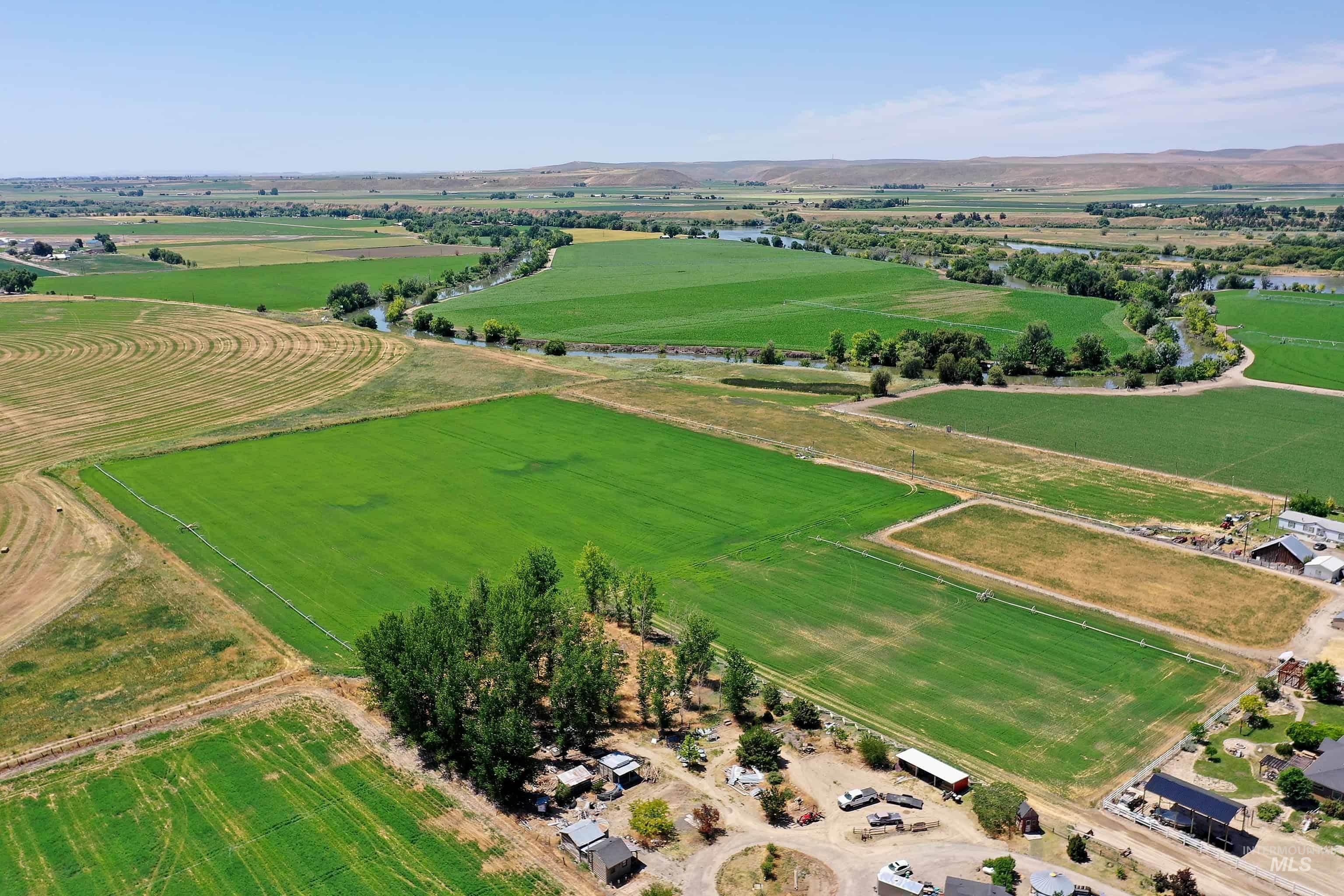Aerial view of sparsely populated area featuring large plots for crops