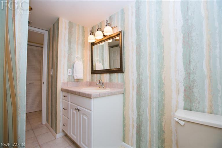 1342 Sand Castle Road Sanibel, FL 33957 - Photo 11 of 17 a bathroom with a sink a toilet and a mirror