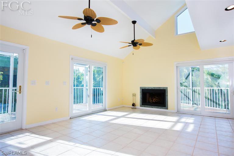 1342 Sand Castle Road Sanibel, FL 33957 - Photo 4 of 17 a view of an empty room with a fireplace and a window