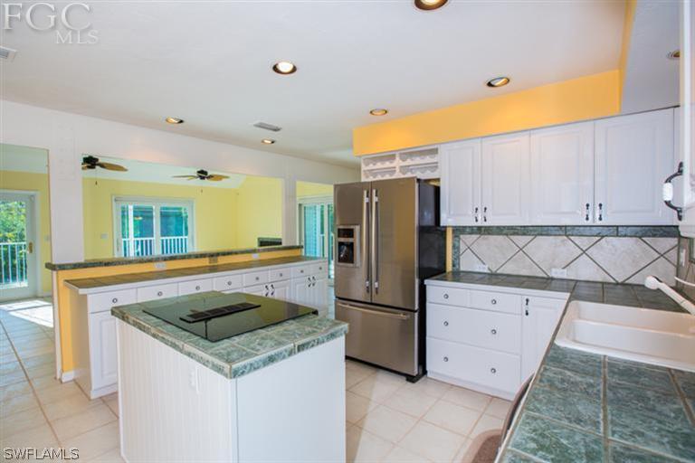 1342 Sand Castle Road Sanibel, FL 33957 - Photo 5 of 17 a kitchen filled with stainless steel appliances granite countertop a refrigerator and a stove